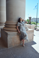 a lady in a blue floral print dress